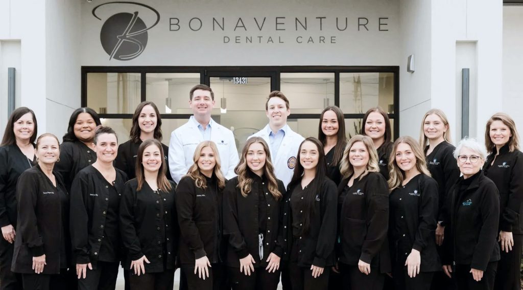 A team picture of Bonaventure Dental Care team, in front of their practice building.